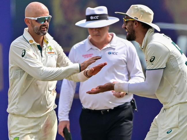 Australia's Nathan Lyon (L) celebrates with Mitchell Starc (R) after taking the wicket of Sri Lanka's Kusal Mendis during the fourth day of the first Test cricket match between Sri Lanka and Australia at the Galle International Cricket Stadium in Galle on February 1, 2025. (Photo by Ishara S. KODIKARA / AFP)