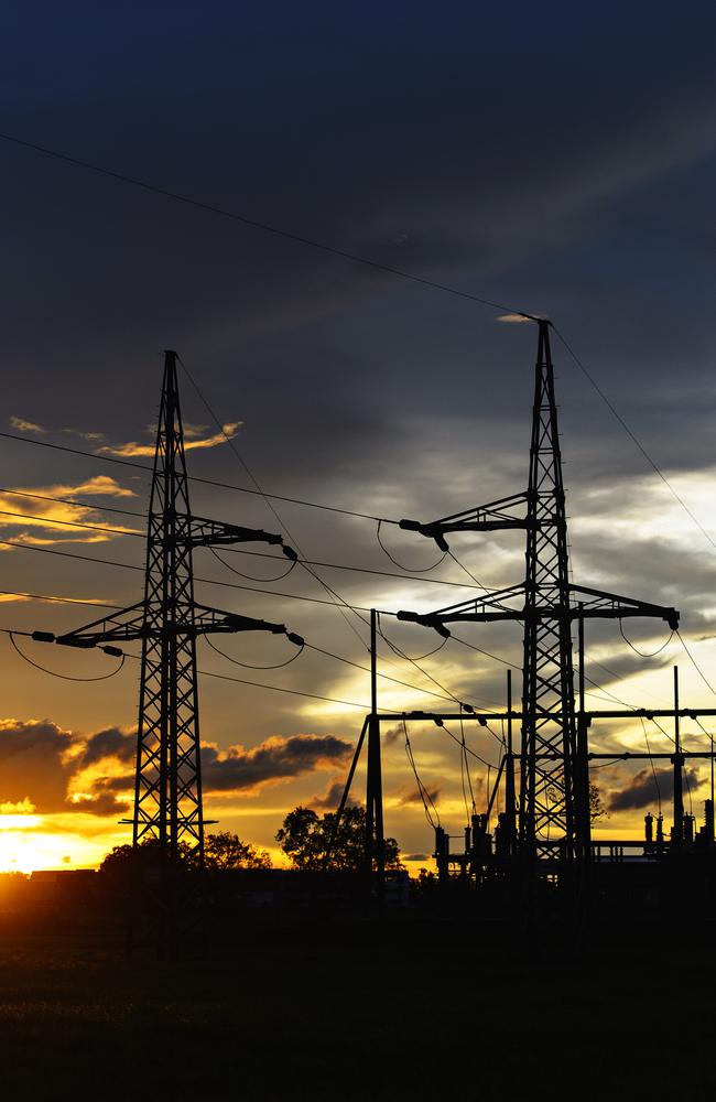 PowerWater electricity infrastructure and power lines at sunset in the Northern Territory.