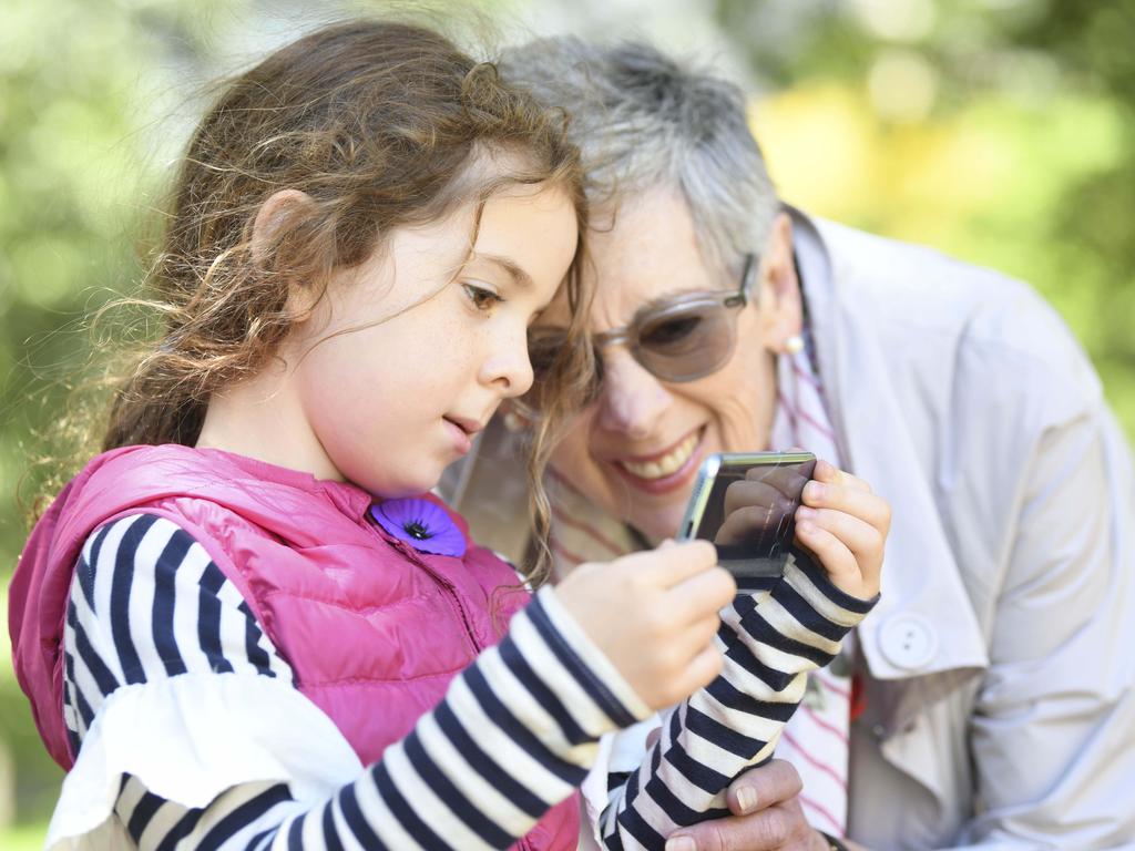 You can view the Anzac360 videos well on a phone … Maggie Johnson, the grand-daughter of famous WW1 nurse Alice Ross King, and her own grand-daughter, Emily Schranz, demonstrate. Picture: Darren Leigh Roberts