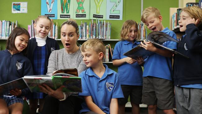 Woolooware Public School Year 2 students Olivia, Elke, teacher Jill Grant, Max, Darcy, Louis and Jedd check out the latest books at the school library. Picture: John Feder/The Australian