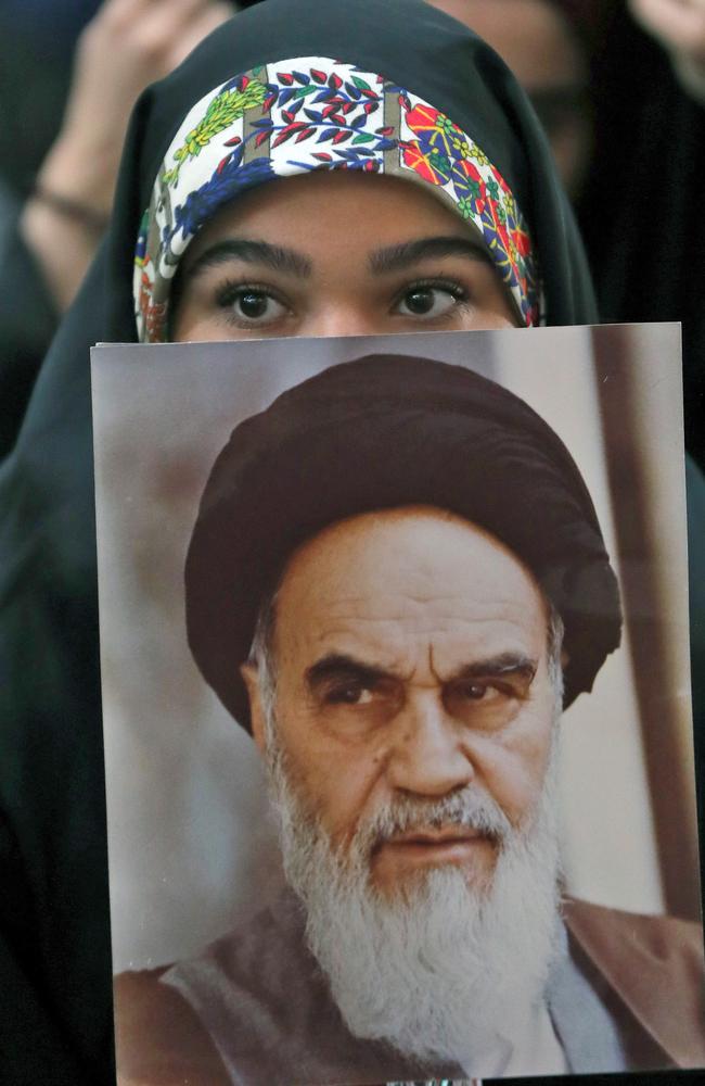 An Iranian girl holds a poster of Iran's late founder of the Islamic Republic, Ayatollah Ruhollah Khomeini, on February 01, 2019. Picture: STR / AFP