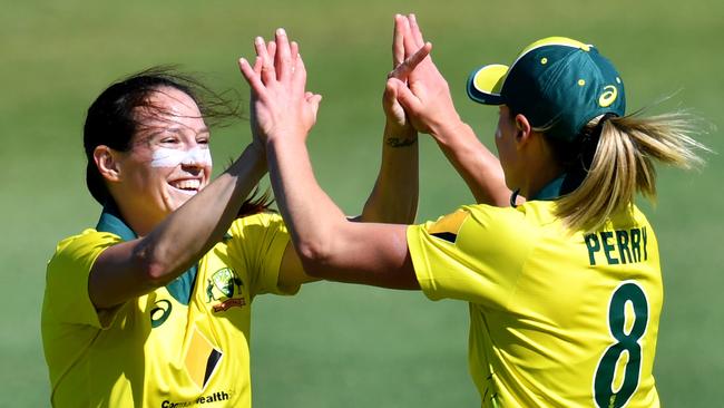 Megan Schutt (left) of Australia celebrates with Ellyse Perry (right) after getting the wicket of Jess Watkin of New Zealand during the second match of the Women's Twenty20 (T20) Series between Australia and New Zealand at the Allan Border Field in Brisbane, Monday, October 1, 2018. (AAP Image/Darren England) NO ARCHIVING, EDITORIAL USE ONLY, IMAGES TO BE USED FOR NEWS REPORTING PURPOSES ONLY, NO COMMERCIAL USE WHATSOEVER, NO USE IN BOOKS WITHOUT PRIOR WRITTEN CONSENT FROM AAP