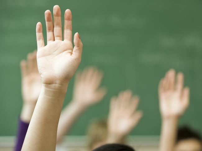 Hands raised in classroom  Picture: istock