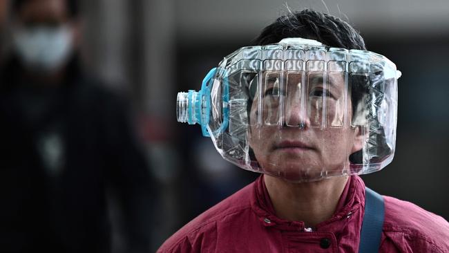 A woman wears a plastic water bottle in Hong Kong in January after coronavirus emerged in mainland China. Picture: AFP