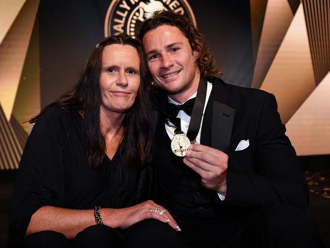 Nicho Hynes with his mum and the Dally M medal.