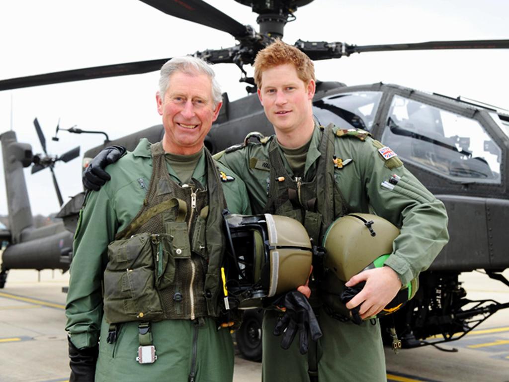 Prince Harry and his father, the Prince Charles, Prince of Wales, stand in front of an Apache Helicopter in 2011. Picture: Getty