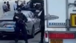 Heavily armed police at the scene of a shooting on the M1. Picture: 7 News