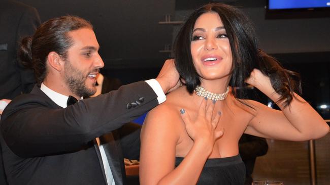 Michael Brunelli and Martha Kalifatidis play with a pearl necklace at the ball. Picture: Fiona Byrne