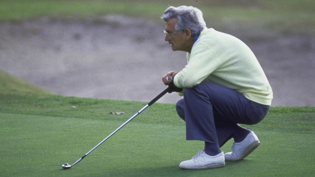 Hawke, squatting on golf course with his club. Picture: Getty Images