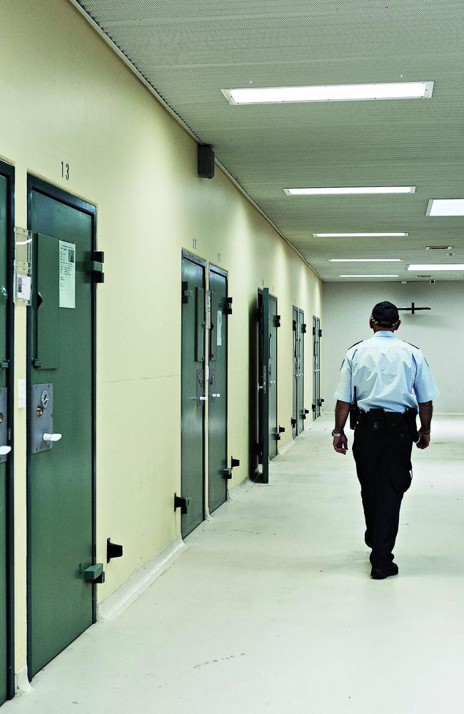 Officer in the corridor outside a row of cell doors at Supermax prison in Goulburn. Picture: Guy Bailey