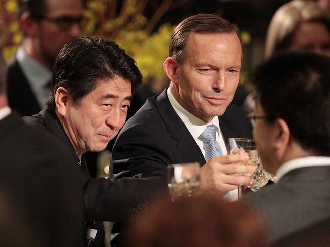 Cheers … Japanese Prime Minister Shinzo Abe and Tony Abbott toast after the two countries signed a historic free trade agreement. Picture: Stefan Postles/Getty Images