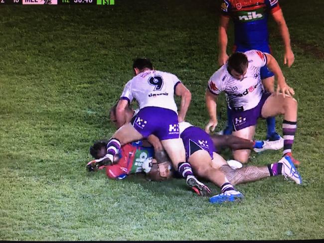 Three Storm players peel off the tackle one by one.