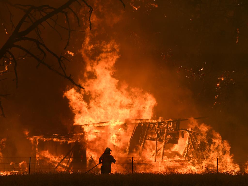 NSW Rural Fire Service crews fight the Gospers Mountain Fire as it impacts a structure at Bilpin, Saturday, December 21, 2019. Conditions are expected to worsen across much of NSW as temperatures tip 40C. Picture: AAP / Dan Himbrechts