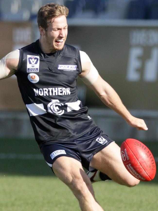 Kane Lambert gets a kick away for Northern Blues in the VFL in 2013.