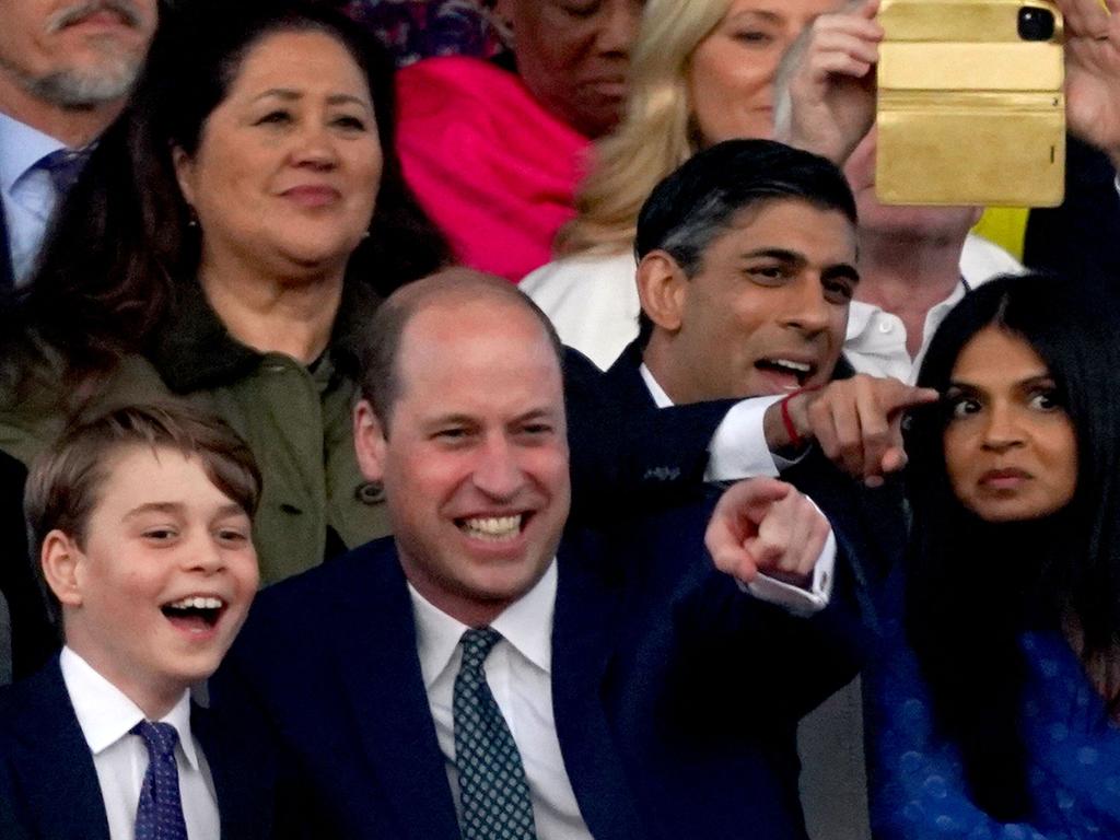 Prince George and his father Prince William enjoy a laugh together as Prime Minister Rishi Sunak and his wife Akshata Murty watch on. Picture: AFP