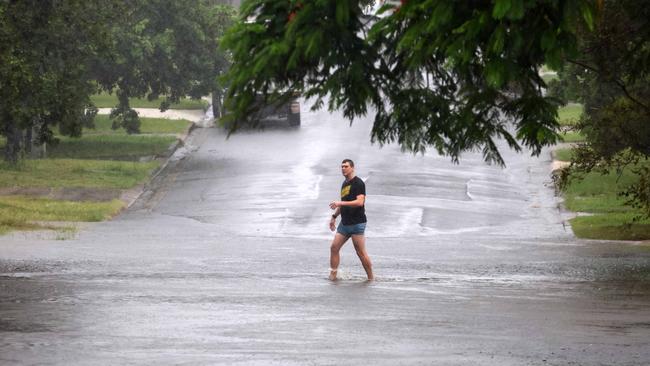 BRISBANE, AUSTRALIA - NewsWire Photos MARCH 9, 2025: Heavy rain and damaging winds continued in the wake of now ex Cyclone Alfred. Shown is a man walking in a flooded road in Carina. Picture: NewsWire/Tertius Pickard