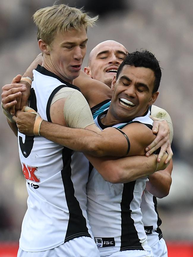 Port Adelaide’s Todd Marshall, Sam Powell-Pepper and Lindsay Thomas celebrate a goal against Carlton. Picture: AAP Image/Julian Smith