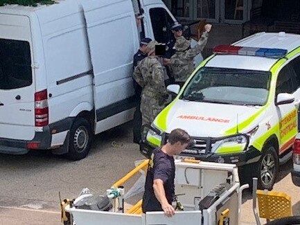 Tactical Response Group officers liaise with NT police officers at the scene of the siege. Picture: Katrina Bridgeford