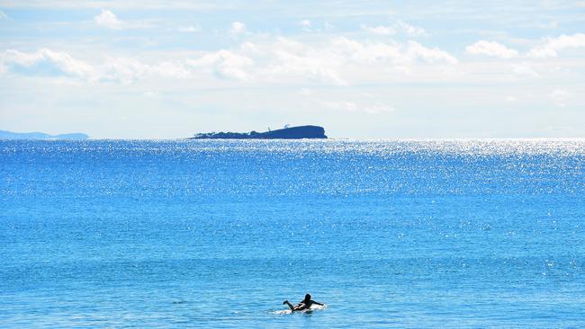 A lone surfer and Old Woman Island, Friday June 30, 2017