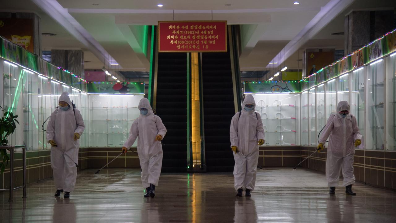 Official picture released from North Korea showing shows employees disinfecting facility as a quarantine measure. Picture: AFP.