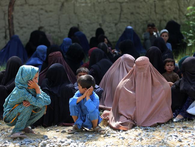 Afghan women along with children wait to receive food aid distributed by International Committee of the Red Cross (ICRC) at Ghani Khel district of Nangarhar province, in the outskirts of Jalalabad on September 4, 2023. (Photo by Shafiullah KAKAR / AFP)