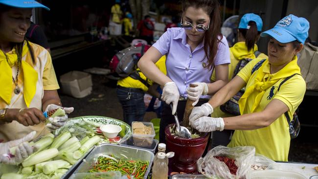 Thai volunteers cook for hundreds of local and foreign rescue personnel at the Tham Luang cave area. Picture: AFP