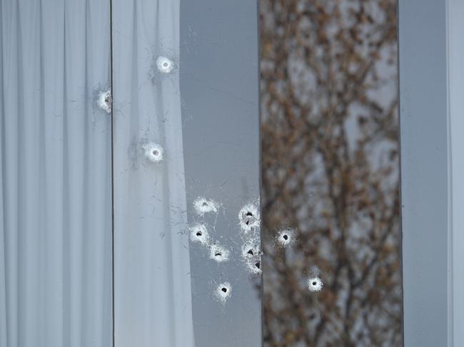 Bullet holes can be seen in the windows of the parents’ house. Picture: David Crosling