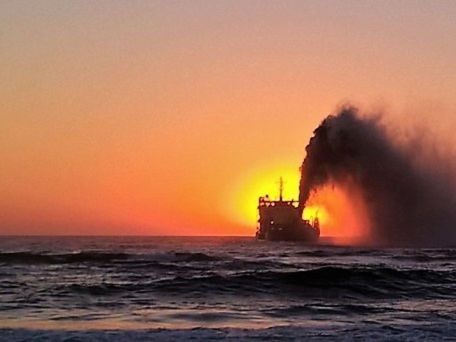 Sunrise behind the sand dredge at North Burleigh Beach Picture by Trevor Maskell
