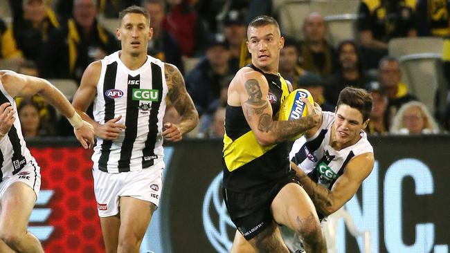 Dustin Martin tries to break away from Collingwood’s Jack Crisp. Picture: George Salpigtidis