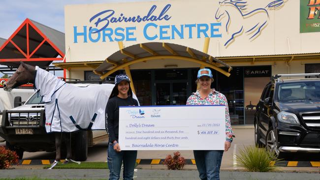 Bairnsdale Horse Centre’s Sarah Ramsay and Carlee Knight with a cheque donated to Dolly's Dream. Picture: Supplied