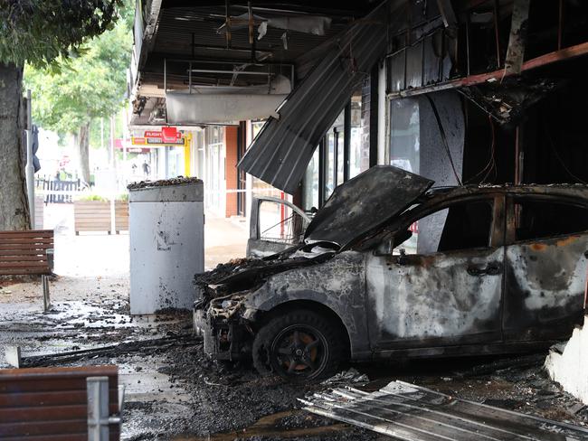 A car was used to ram the front door of this tobacco store in Altona before it was firebombed. Picture: David Crosling