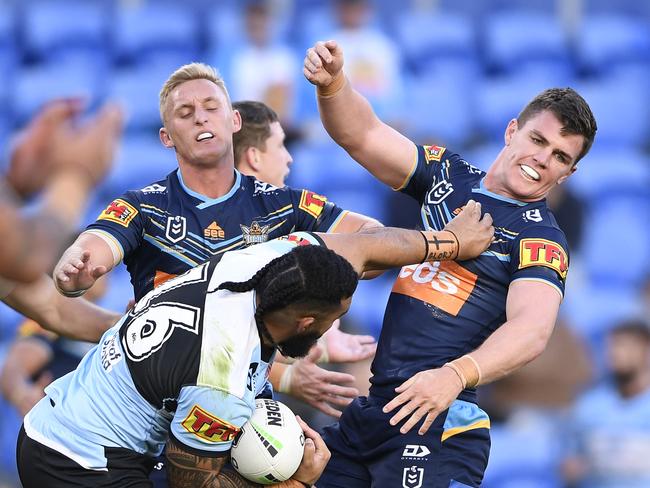 Siosifa Talakai fends off Beau Femor of the Titans. Picture: Ian Hitchcock/Getty Images