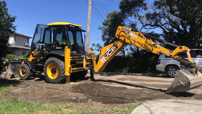 A Northern Beaches Council contractor's digger creates a bank of earth outside a house on Plateau Rd, Avalon on Tuesday to help protect the property from stormwater run-off while roadworks are underway. Picture: Jim O'Rourke