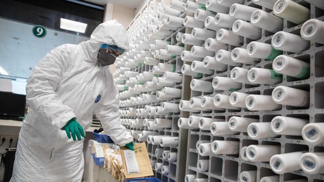 A medical worker produces traditional Chinese medicine to treat patients infected by the COVID-19 coronavirus at a hospital in Wuhan. Picture: AFP