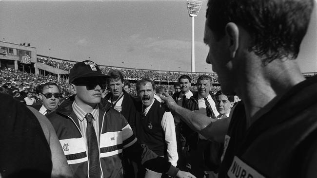 Leigh Matthews has a crack at Terry Daniher at halftime in the 1990 Grand Final.