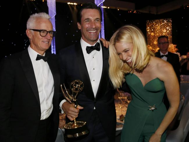 Jon Hamm holds his award for Outstanding Lead Actor in a Drama Series for his role on AMC’s “Mad Men” while mingling with actors John Slattery and January Jones at the 67th Annual Primetime Emmy Awards Governors Ball. Picture: REUTERS/Mario Anzuoni