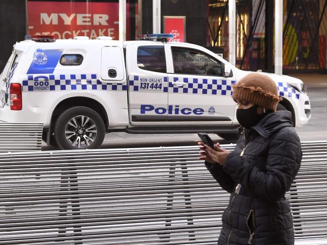 A police vehicle drives through Melbourne's normally bustling Bourke Street Mall on June 4, 2021, as the coronavirus lockdown of Australia's second-biggest city is extended by another seven days, authorities announced. (Photo by William WEST / AFP)