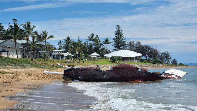 The burnt yacht on November 25, 2022, with the Emu Park Surf Lifesaving Club in the background. Photo Darryn Nufer.