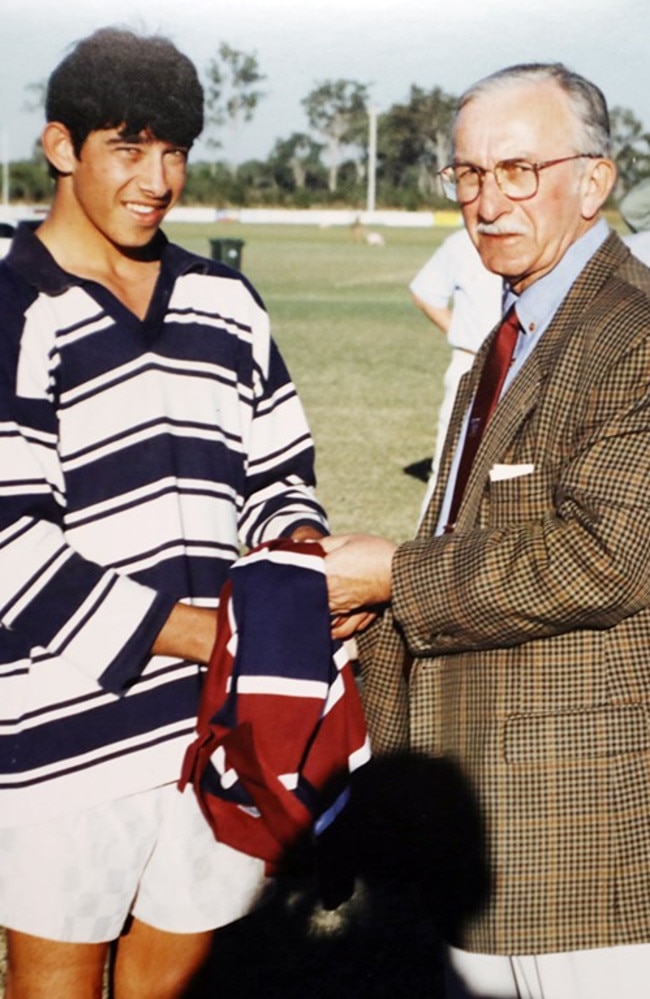 Future NRL great Johnathan Thurston receives his 2000 Confraternity Carnival Team jersey from Brother Ted Magee. Picture: Bundaberg Now