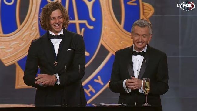 Nat Fyfe and Bruce McAvaney share a laugh on stage.