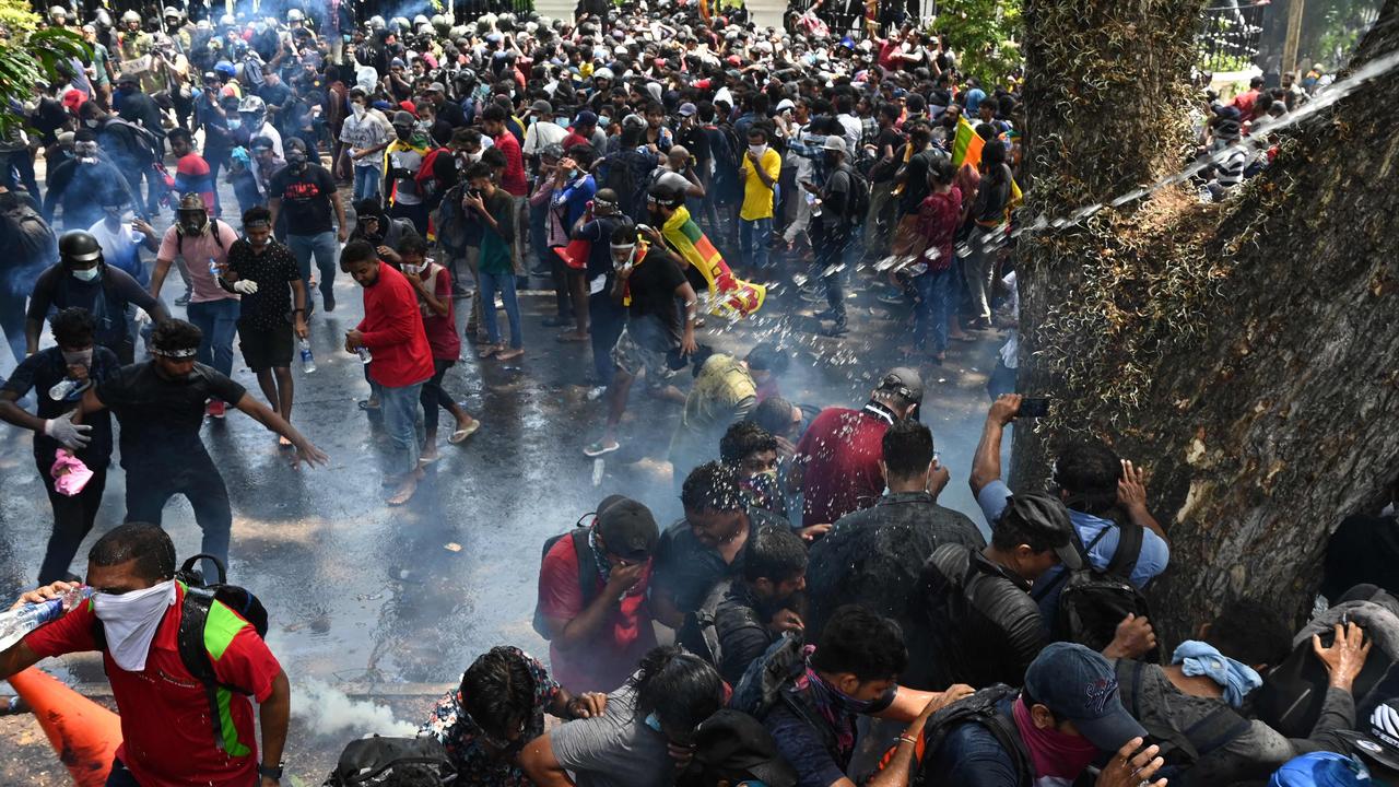 Army personnel use tear gas to disperse demonstrators during an anti-government protest outside the office of Sri Lanka's prime minister on July 13. Picture: Arun Sankar / AFP