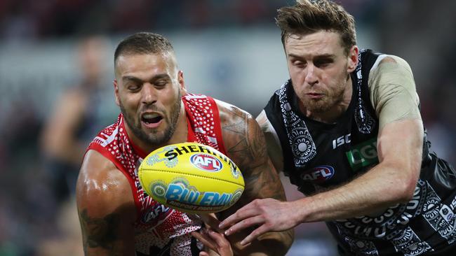 Jordan Roughead gets a hand in to spoil Sydney star Lance Franklin last round. Picture: Phil Hillyard.