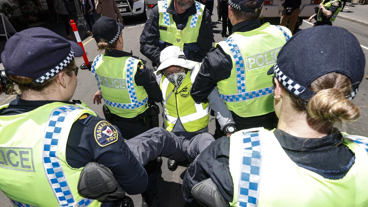 Tasmania Police officers remove an Extinction Rebellion member after a protest last year. Picture: Zak Simmonds