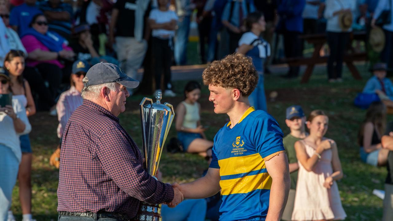 Patric O’Callaghan hands over the O’Callaghan Cup to Grammar First XV captain Joe Gray. Picture: Nev Madsen