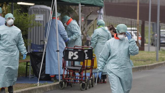 Paramedics work at one of the emergency structures set up to ease procedures at the Brescia hospital, northern Italy. Picture: AP.