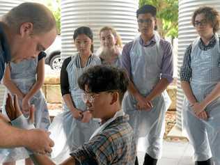 Jacqui Chin, Sophie Olufson, Makesh Gounden and Thomas Thurecht watch 'patient' Thomas Wong get a cast on. Picture: Jann Houley