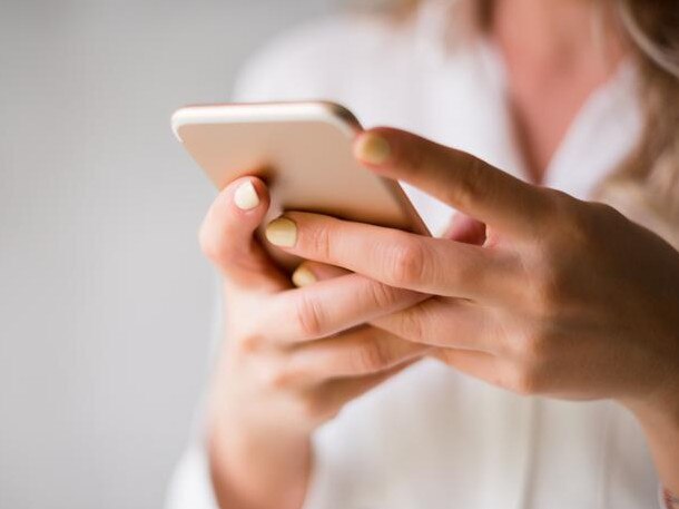 Close up of a woman using her smartphone indoors. generic. istock