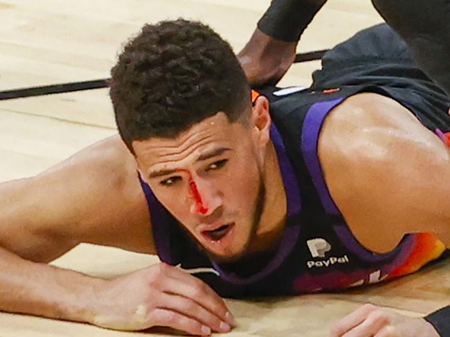 *** BESTPIX *** PHOENIX, ARIZONA - JUNE 22: Devin Booker #1 of the Phoenix Suns is injured from a headbutt during the third quarter in game two of the NBA Western Conference finals against the LA Clippers at Phoenix Suns Arena on June 22, 2021 in Phoenix, Arizona. NOTE TO USER: User expressly acknowledges and agrees that, by downloading and or using this photograph, User is consenting to the terms and conditions of the Getty Images License Agreement.  (Photo by Christian Petersen/Getty Images)