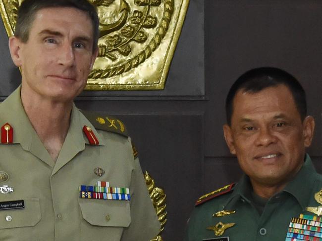 In this handout photograph released by the Indonesian Military (TNI) on February 8, 2017, Indonesian Military Chief Gatot Nurmantyo (R) and Chief of Australian Army Angus Campbell pose for a photo at the military headquarters in Jakarta. Indonesian's military February 8 accepted an apology offered by Canberra after the discovery of offensive training materials at an army base that prompted Jakarta to freeze a training cooperation. RESTRICTED TO EDITORIAL USE - MANDATORY CREDIT 