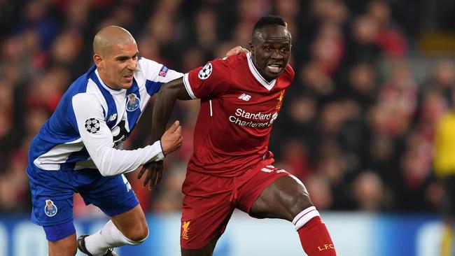 Sadio Mane of Liverpool is challenged by Maximiliano of FC Porto